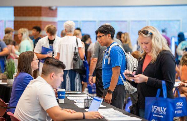 Students and parents at Grand Valley's Orientation sign in.